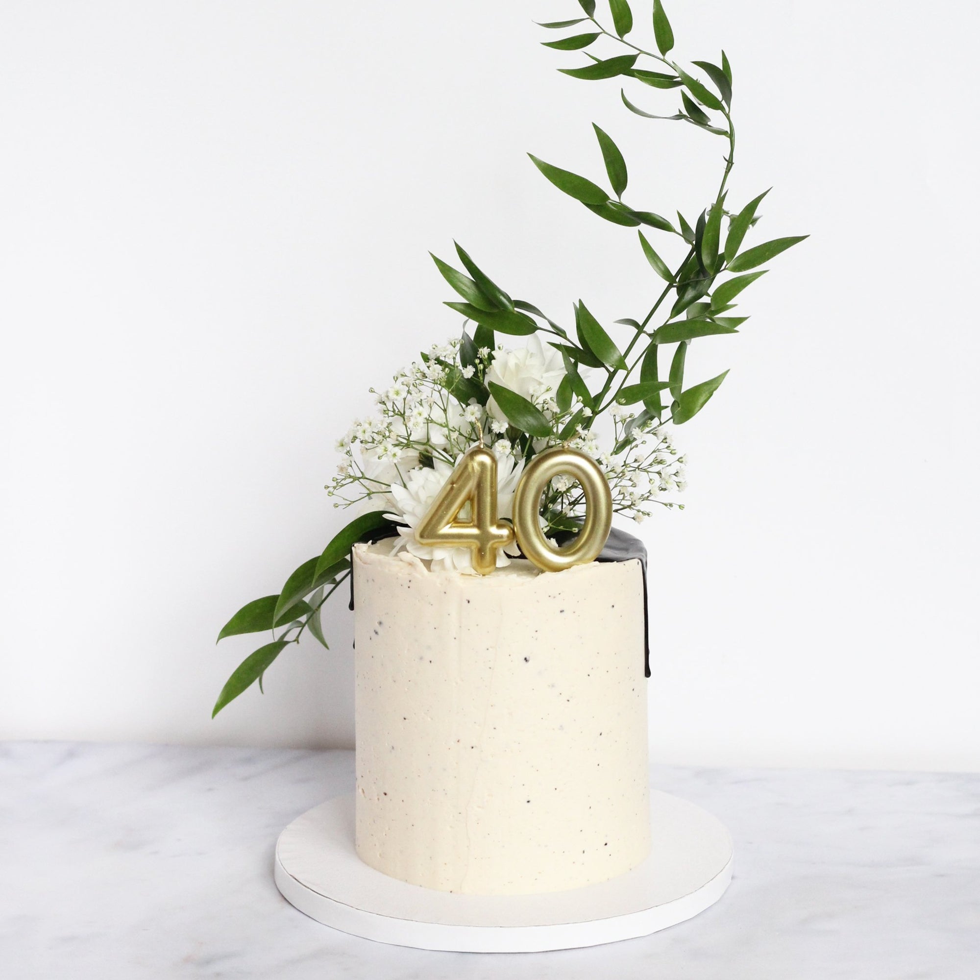 Lady Reserved Cake - chic & simple white icing with dramatic florals & greens.