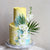 Beach-inspired cake with wavy brushstrokes and a dash of white florals.