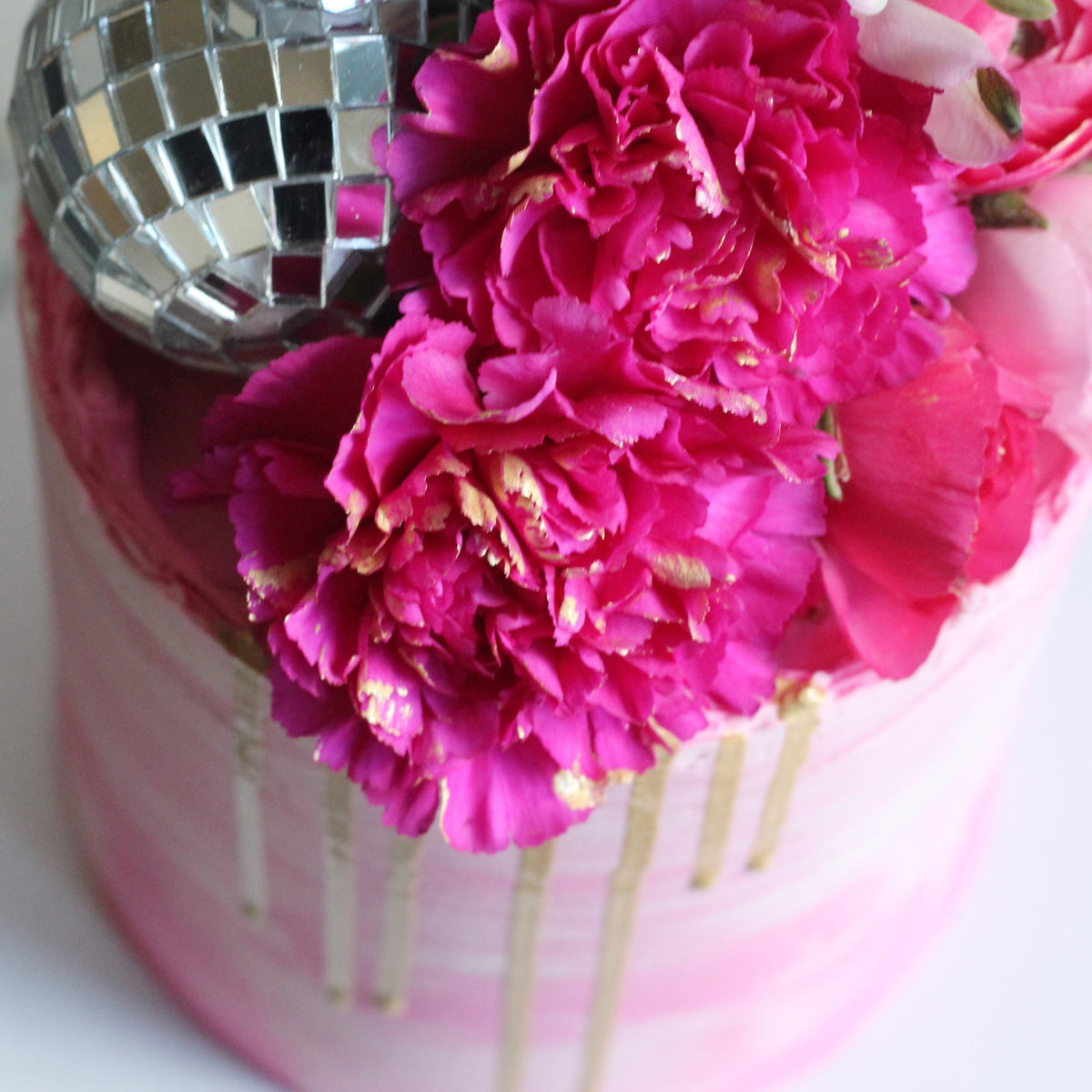 Meet the Golden Hour Cake - a dazzling showpiece for every disco queen! Covered in pink icing, topped with bold florals, shimmering gold drip, and sparkling disco balls. Perfect for birthdays, parties, and glamorous celebrations.