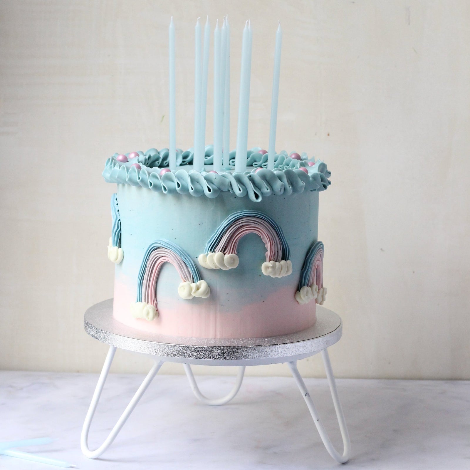 Our Rainbow Cake with blue & pink ombre icing, 3D rainbows and creamy ruffles!